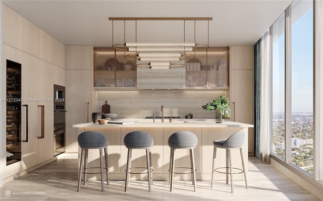 bar featuring decorative light fixtures, sink, light hardwood / wood-style floors, and floor to ceiling windows