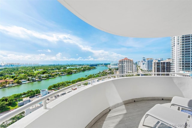 balcony with a water view and a city view