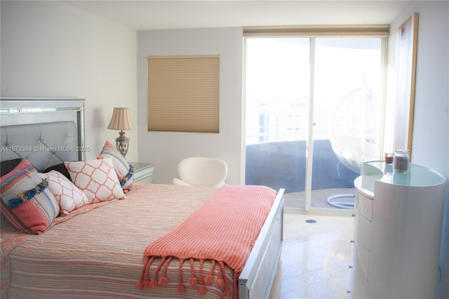 bedroom featuring access to exterior, floor to ceiling windows, multiple windows, and light floors