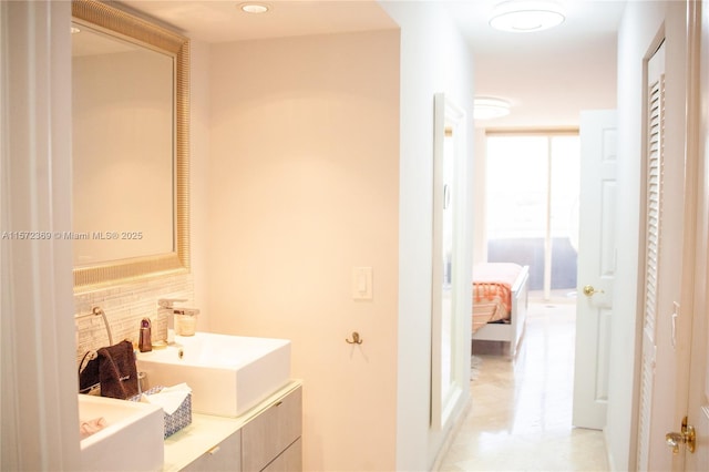 full bathroom with double vanity, tasteful backsplash, and a sink