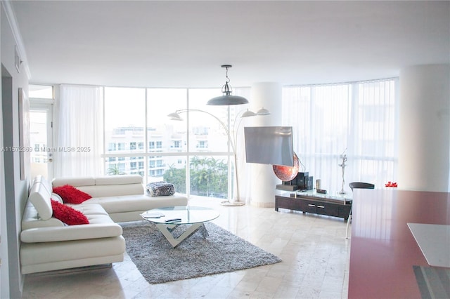 living room featuring plenty of natural light and a wall of windows