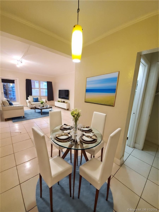 tiled dining space featuring crown molding