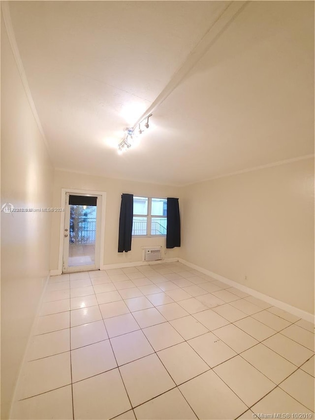 spare room with crown molding, track lighting, and light tile floors