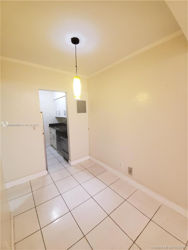 unfurnished dining area featuring ornamental molding and light tile floors