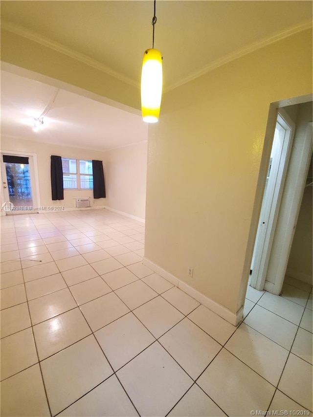 tiled empty room featuring ornamental molding