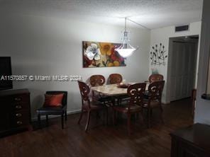 dining area with dark hardwood / wood-style flooring