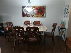 dining space with dark wood-type flooring