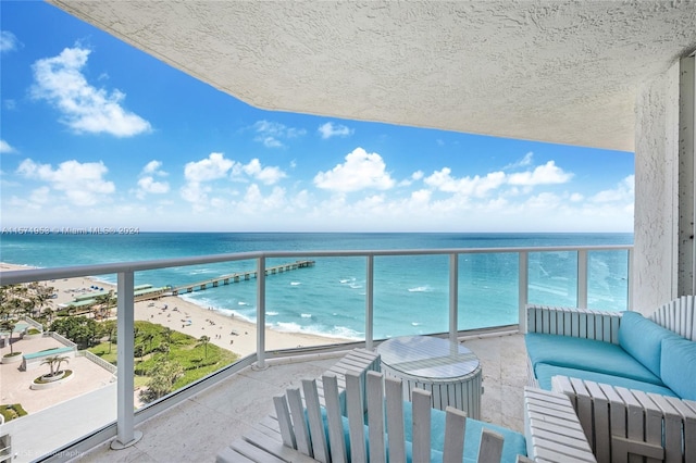 balcony with a beach view and a water view