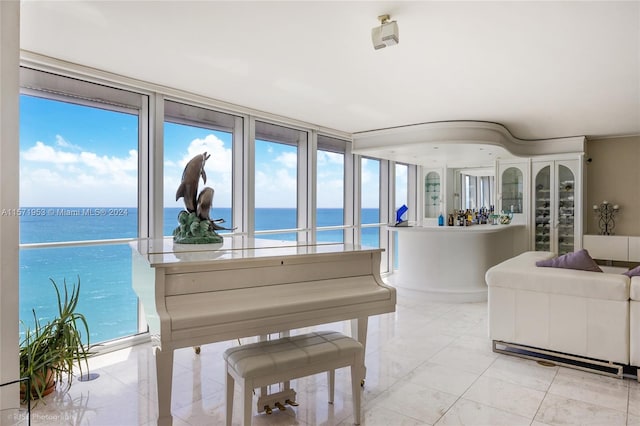 living room with tile flooring and a water view