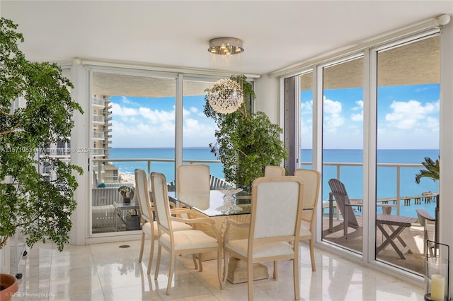 sunroom / solarium featuring a water view