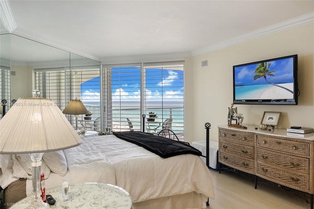 bedroom featuring light wood-type flooring and crown molding