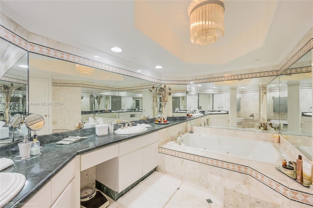 bathroom featuring oversized vanity, dual sinks, a tray ceiling, tile floors, and tiled bath