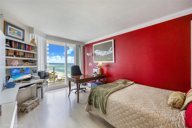 bedroom with a water view, ornamental molding, hardwood / wood-style flooring, and access to outside