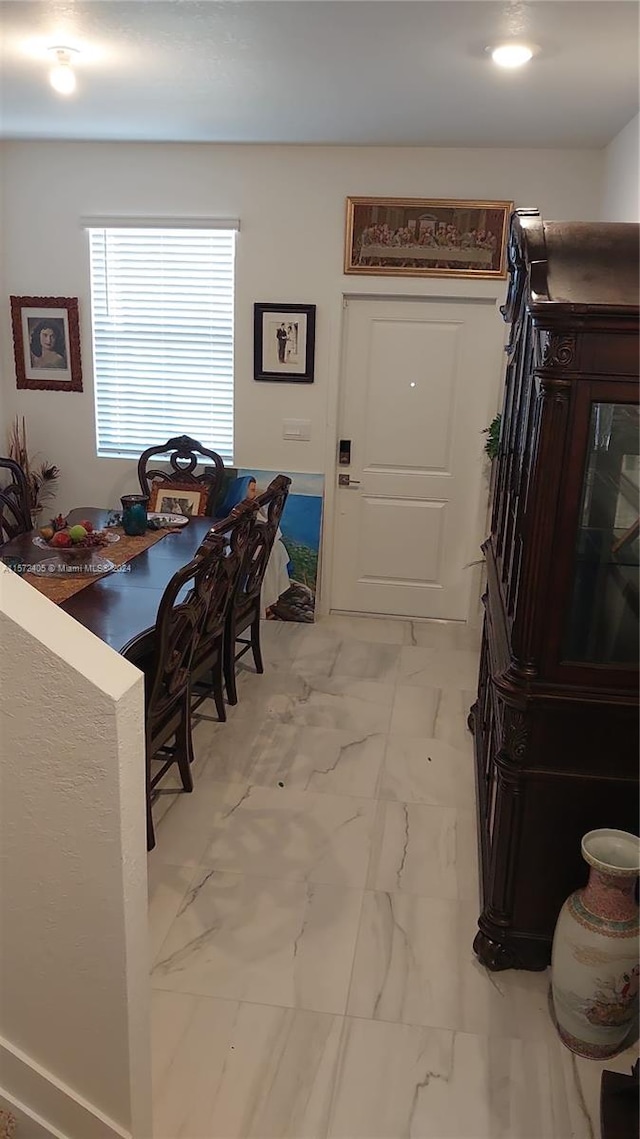 dining space with light tile flooring