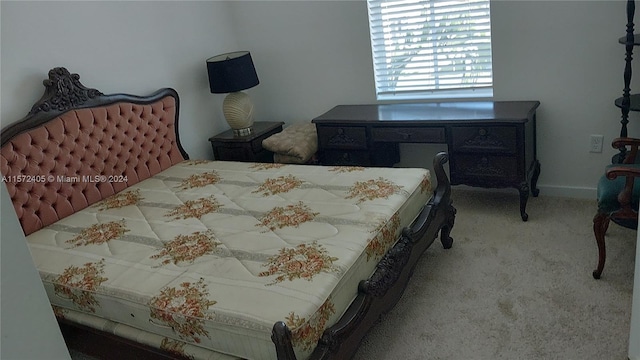 bedroom featuring light colored carpet