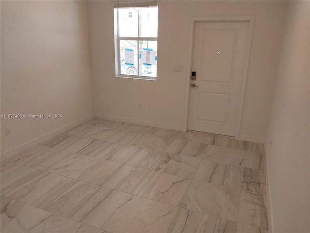 spare room featuring light tile floors