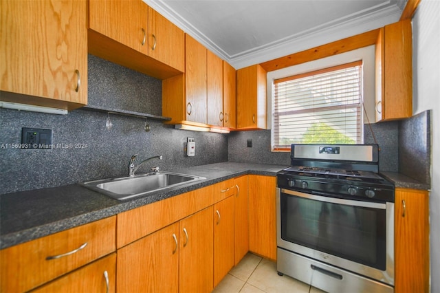 kitchen with gas stove, light tile floors, sink, backsplash, and ornamental molding