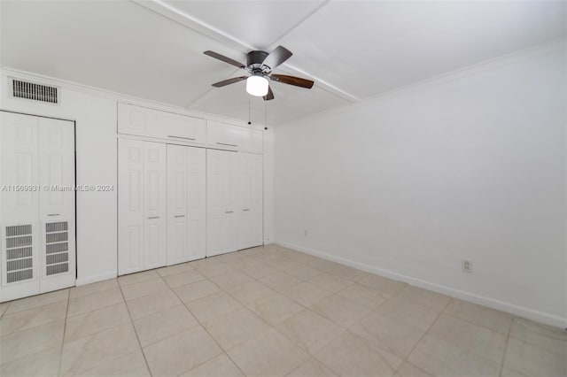 unfurnished bedroom with crown molding, ceiling fan, and light tile floors