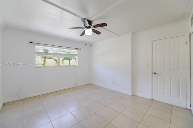 tiled empty room featuring crown molding and ceiling fan