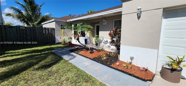 doorway to property featuring a yard