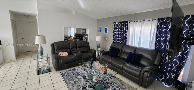 living room featuring lofted ceiling, light tile floors, and a textured ceiling