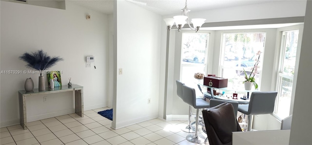 dining room with a notable chandelier and light tile floors