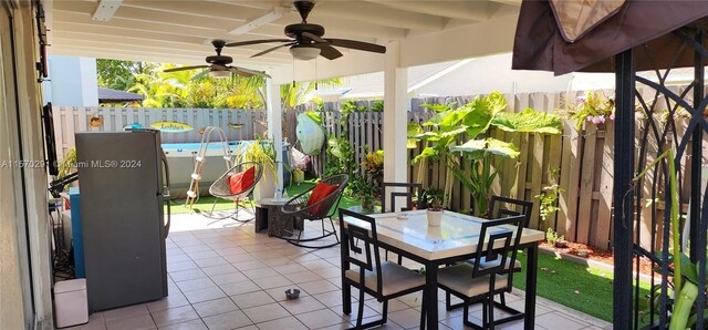 view of terrace with a swimming pool and ceiling fan