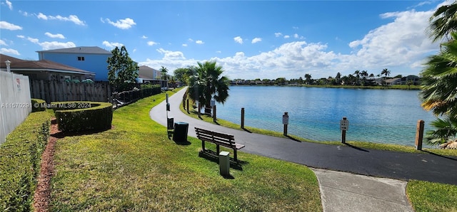 view of home's community featuring a water view and a lawn