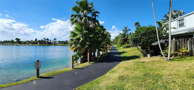 exterior space with a water view and a lawn