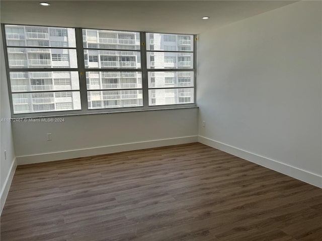 spare room featuring dark wood-type flooring