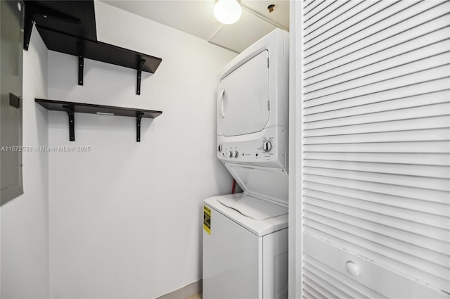 clothes washing area with stacked washer and dryer