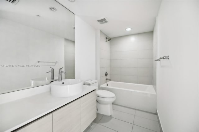 full bathroom featuring tile patterned floors, vanity, toilet, and tiled shower / bath