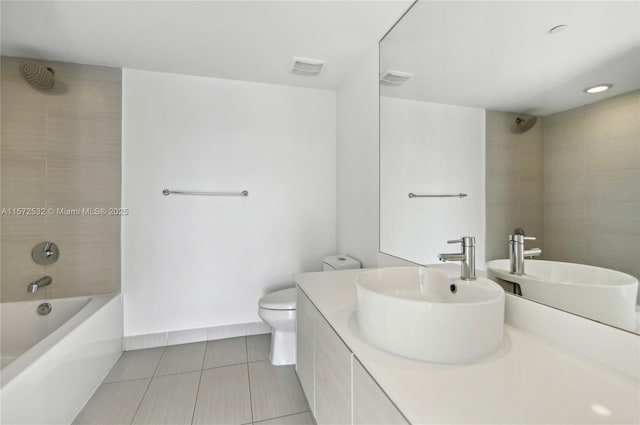 full bathroom featuring tile patterned floors, vanity, toilet, and tiled shower / bath