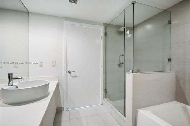 bathroom featuring tile patterned floors, vanity, and plus walk in shower