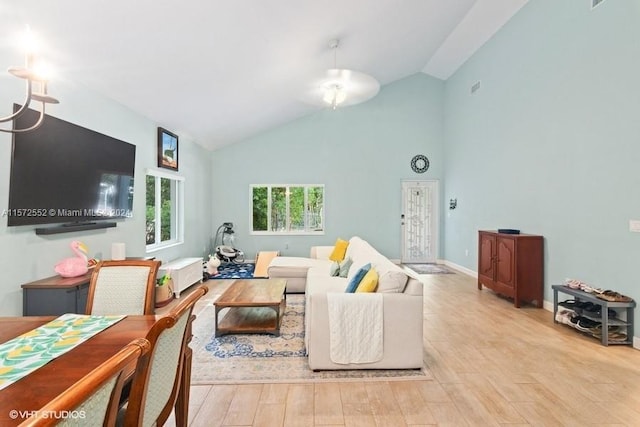 living room featuring light hardwood / wood-style flooring and high vaulted ceiling