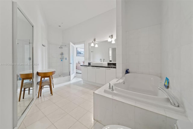 bathroom featuring independent shower and bath, vanity, and tile patterned floors