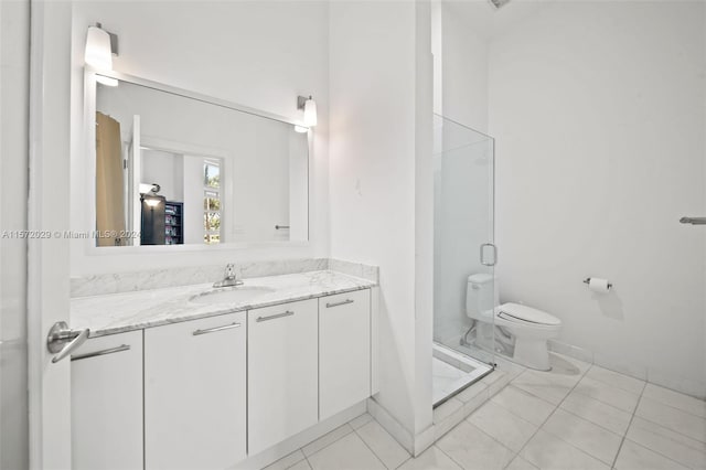 bathroom with an enclosed shower, vanity, and toilet