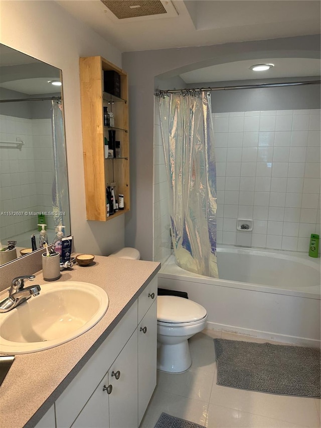 full bathroom with tile flooring, shower / tub combo, vanity, and toilet