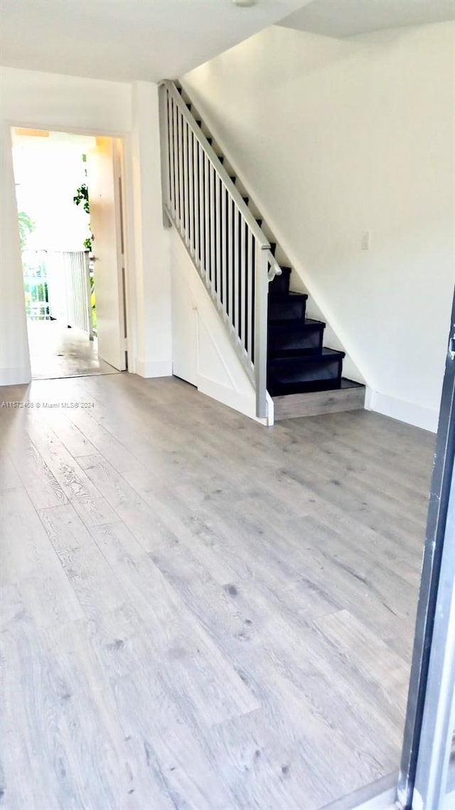 stairway with hardwood / wood-style floors