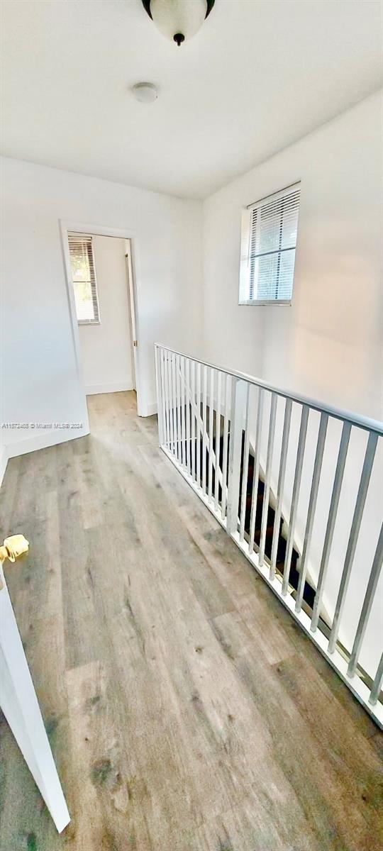 corridor with hardwood / wood-style floors