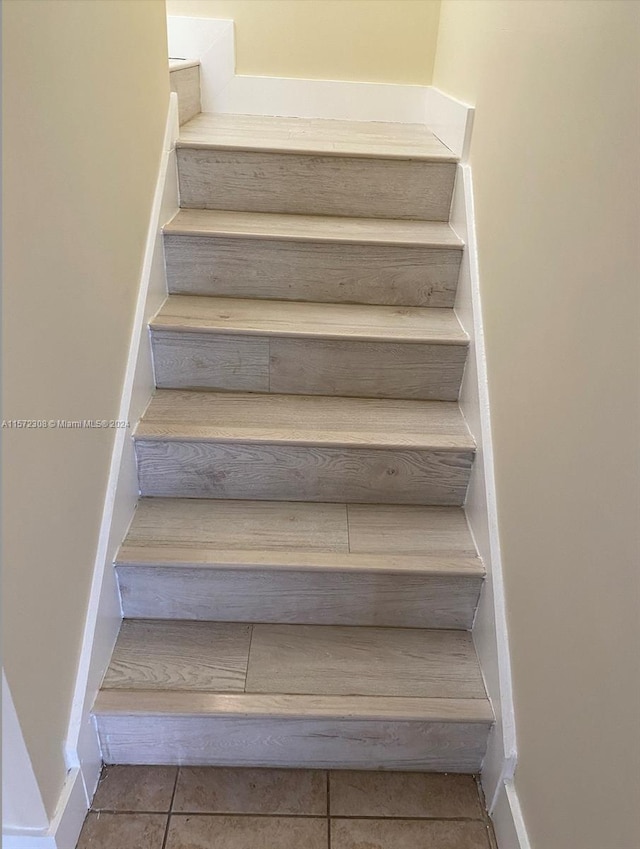 staircase with tile patterned flooring