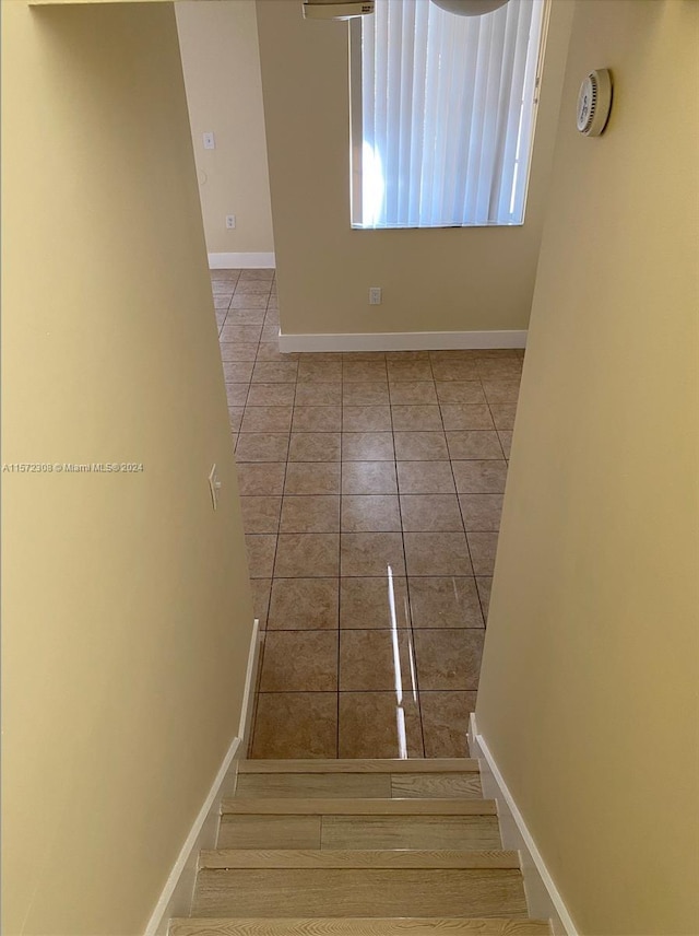 stairs with tile patterned floors