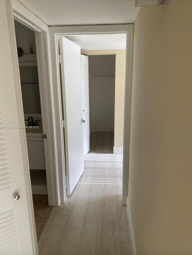 corridor with light hardwood / wood-style flooring