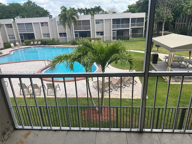 view of pool with a yard and a patio area