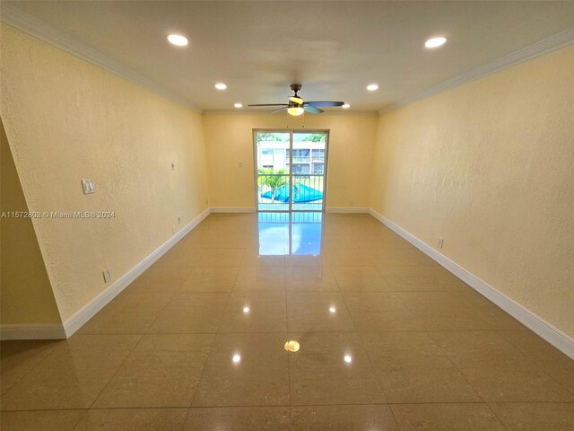 spare room with crown molding and ceiling fan