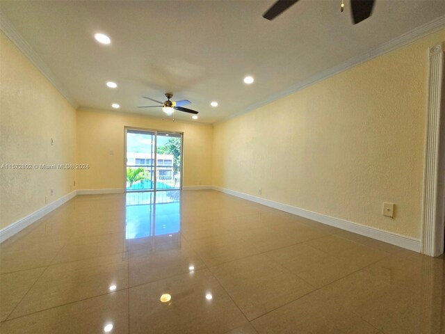 unfurnished room with crown molding, tile patterned floors, and ceiling fan