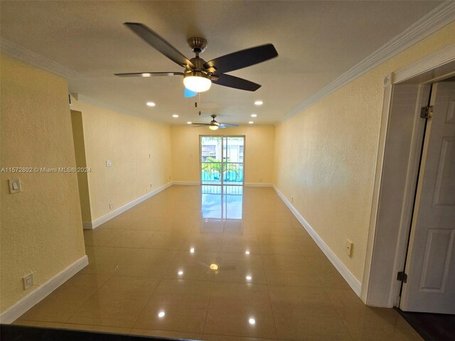 spare room featuring crown molding and tile patterned floors