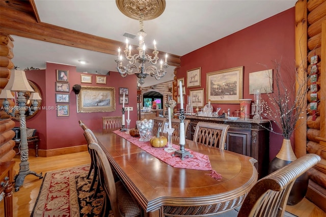 dining area featuring a notable chandelier and light hardwood / wood-style flooring