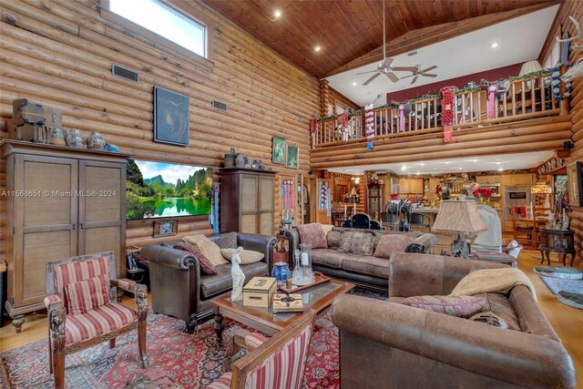 living room featuring ceiling fan, plenty of natural light, high vaulted ceiling, wooden ceiling, and light wood-type flooring