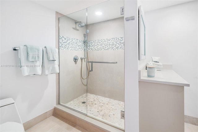 bathroom with a shower with shower door, tile floors, and toilet